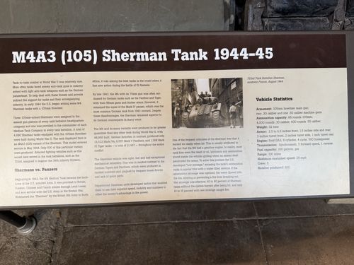 Interpretive placard titled 'M4A3 (105) Sherman Tank 1944-45' with body text, a 'Shermans vs. Panzers' section, a historic photo, and a Vehicle Statistics box.