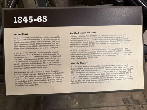 Close-up of a black gallery placard titled '1845-65' with three sections of text about the Twin Sisters cannons of San Jacinto and their fate during the Civil War era.