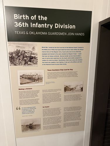 Tall wall panel titled 'Birth of the 36th Infantry Division - Texas & Oklahoma Guardsmen Join Hands', with historic photos of soldiers in trenches and formations, and sections headed 'Texas Guardsmen Help Lead the Way', 'Making a Division', and 'To France'.