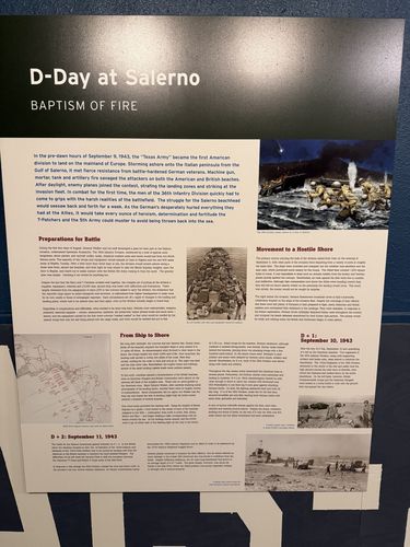 Large wall panel titled 'D-Day at Salerno / Baptism of Fire', with a color painting of a beach landing, a map, and text columns under 'Preparations for Battle', 'Movement to a Hostile Shore', 'From Ship to Shore', and dated subheads for September 10/11, 1943.