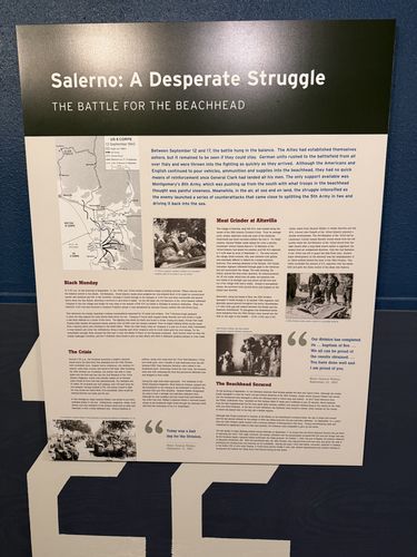 Large wall panel titled 'Salerno: A Desperate Struggle / The Battle for the Beachhead', with a map of US 6 Corps (13 September 1943) and text columns under 'Black Monday', 'The Crisis', 'Meat Grinder at Altavilla', and 'The Beachhead Secured'.