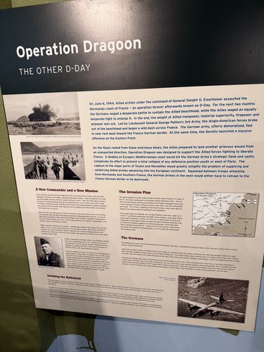 Large wall panel titled 'Operation Dragoon / The Other D-Day', with a beach-landing photo, a 'Operation Dragoon U.S. Seventh Army' map of the Mediterranean coast, and text columns under 'A New Commander and a New Mission', 'The Invasion Plan', 'The Germans', and 'Isolating the Battlefield'.