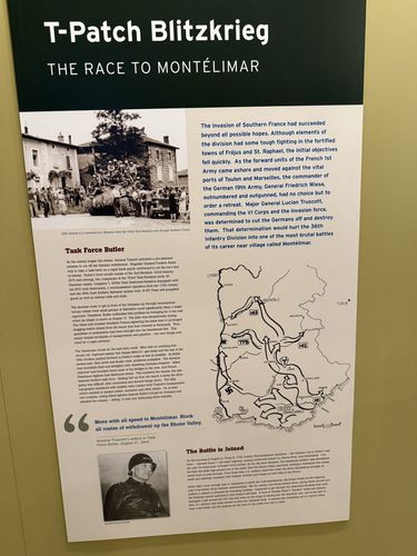 Wall panel titled 'T-Patch Blitzkrieg' with a photo of soldiers riding a Sherman tank, a map of the Rhone Valley showing German and French unit positions, and a portrait of a general at the bottom.