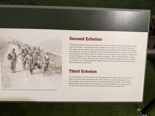 Angled panel with a black-and-white photo of helmeted medics walking on a road, and two text blocks: 'Second Echelon' and 'Third Echelon'. The photo caption mentions the Rapido River.