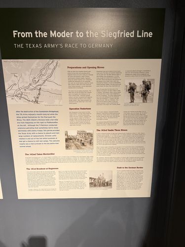 Straight-on photo of a tall interpretive panel titled 'From the Moder to the Siegfried Line - The Texas Army's Race to Germany', with a map and several text sections (Preparations and Opening Moves, Operation Undertone, The 142nd Takes Mertzwiller, The 141st Breakout at Haguenau, The 143rd Vaults Three Rivers, Dash to the German Border).