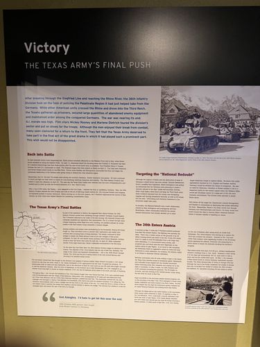 Straight-on photo of a large panel titled 'Victory - The Texas Army's Final Push', with a photograph of American halftracks/vehicles, and sections Back into Battle, The Texas Army's Final Battles, Targeting the National Redoubt, The 36th Enters Austria.